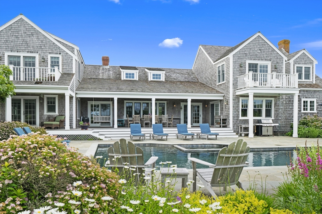 a house view with sitting space garden view with a outdoor space