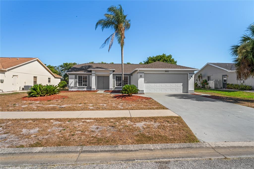 a front view of a house with a yard and garage