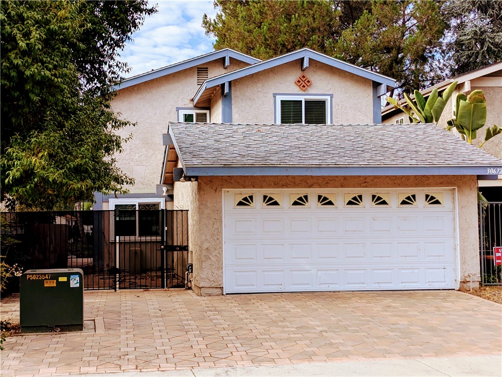 a front view of a house with garage