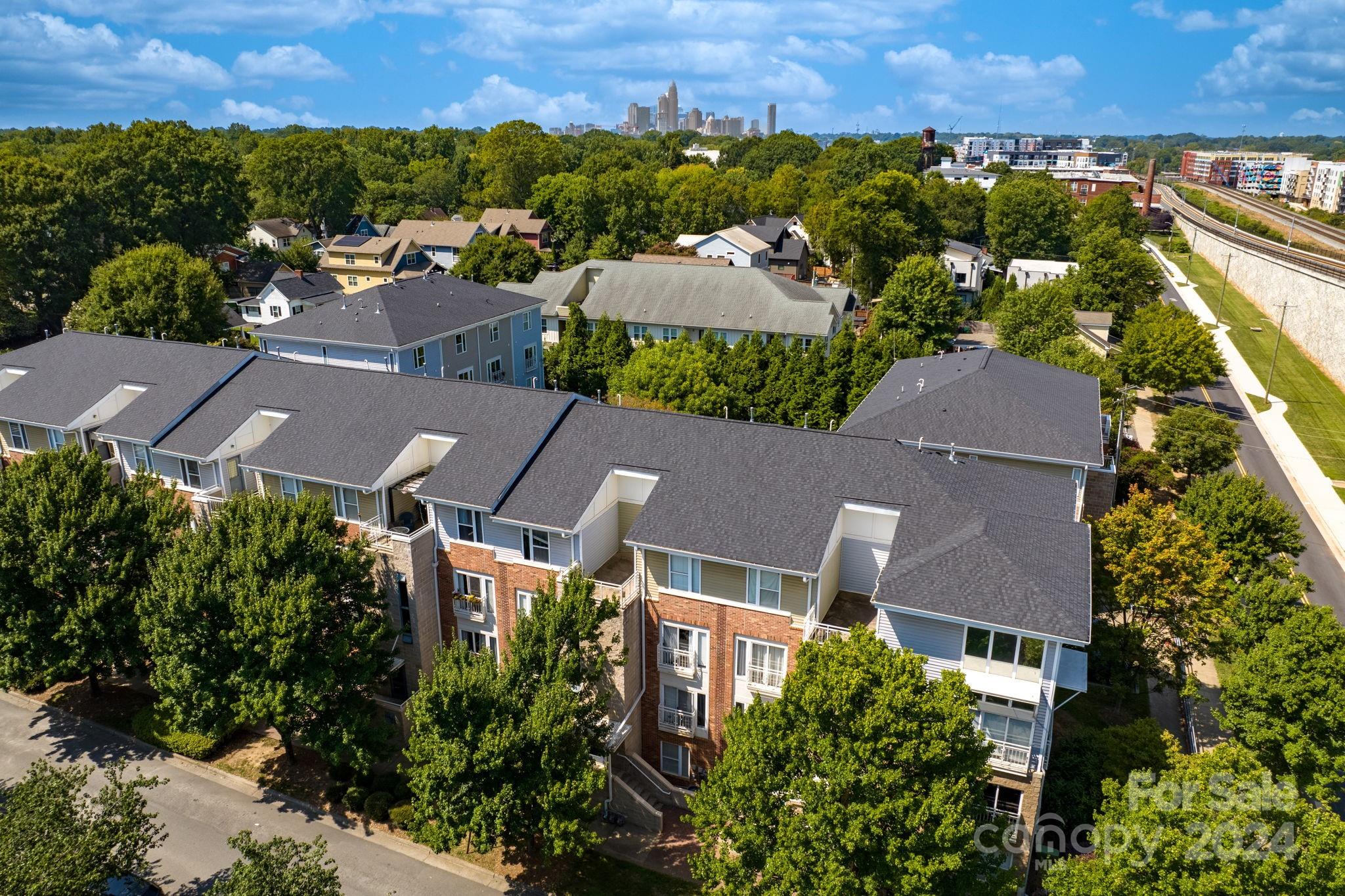 an aerial view of residential houses with outdoor space and a lake view