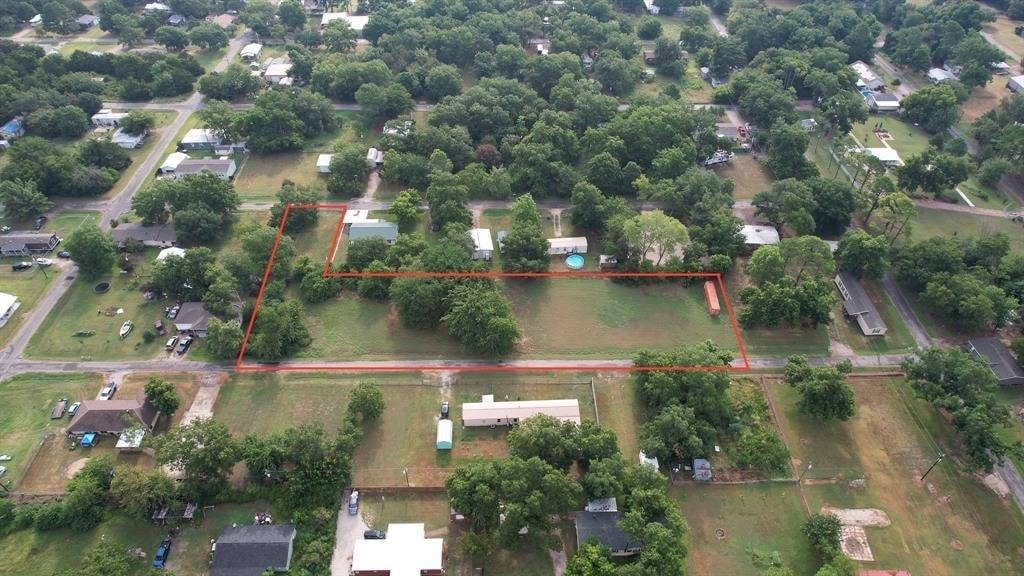 an aerial view of residential houses with outdoor space and lake view