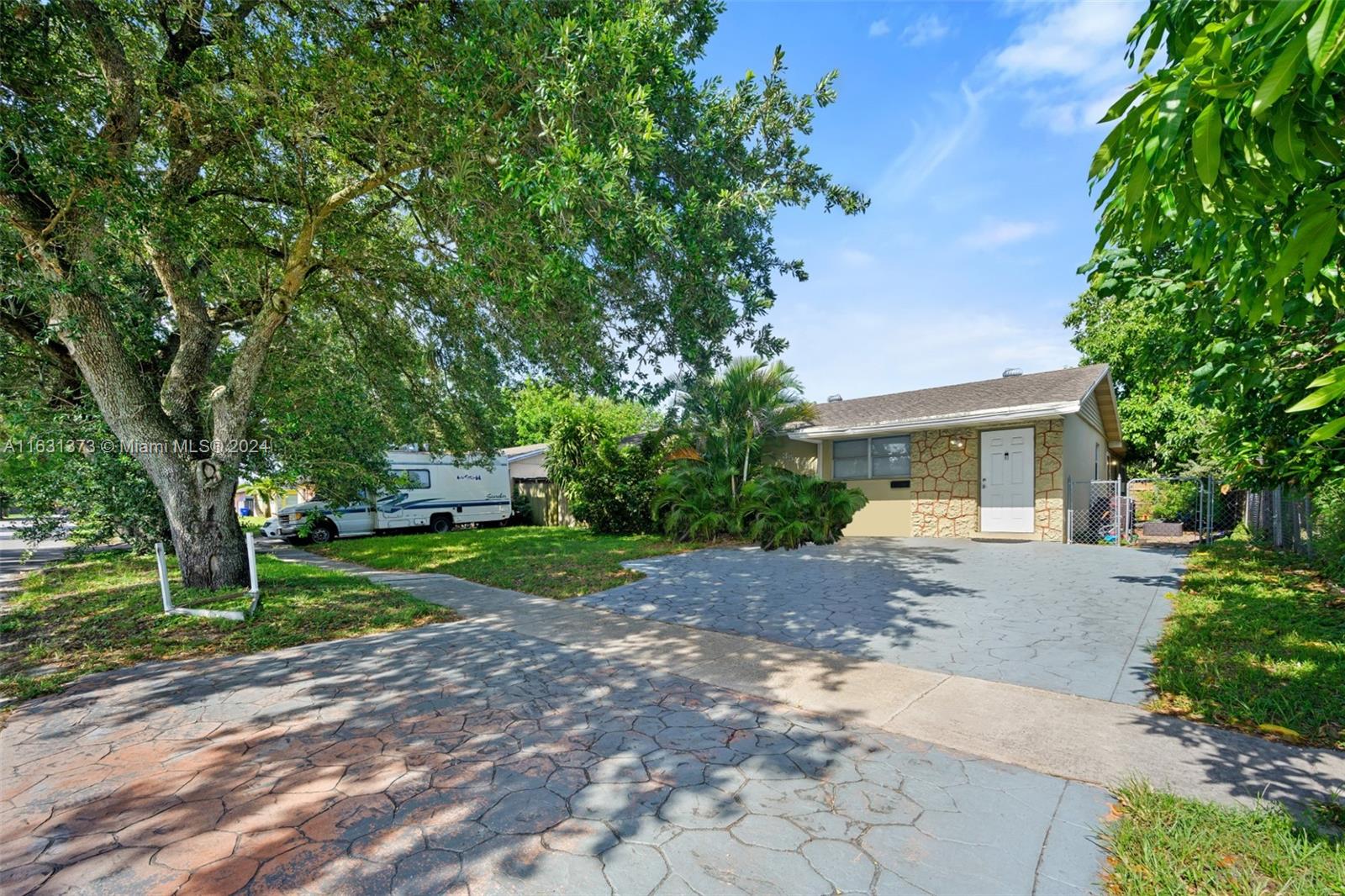 a view of a house with a yard and tree s