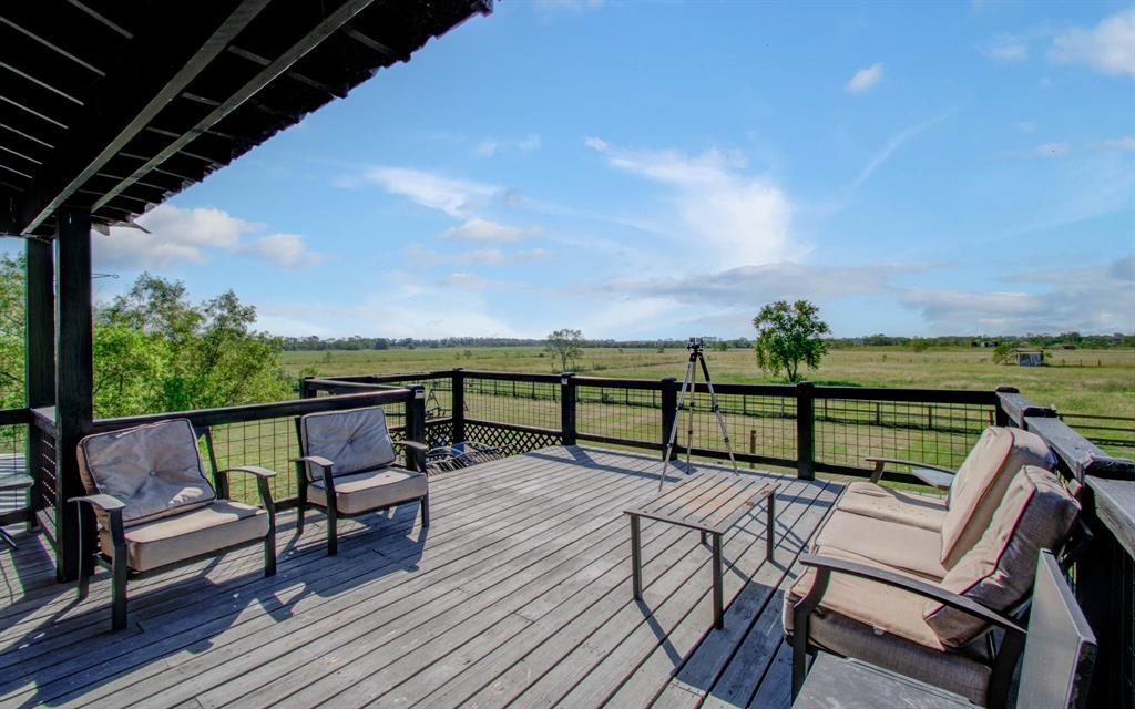 a view of a chairs and table on the wooden deck