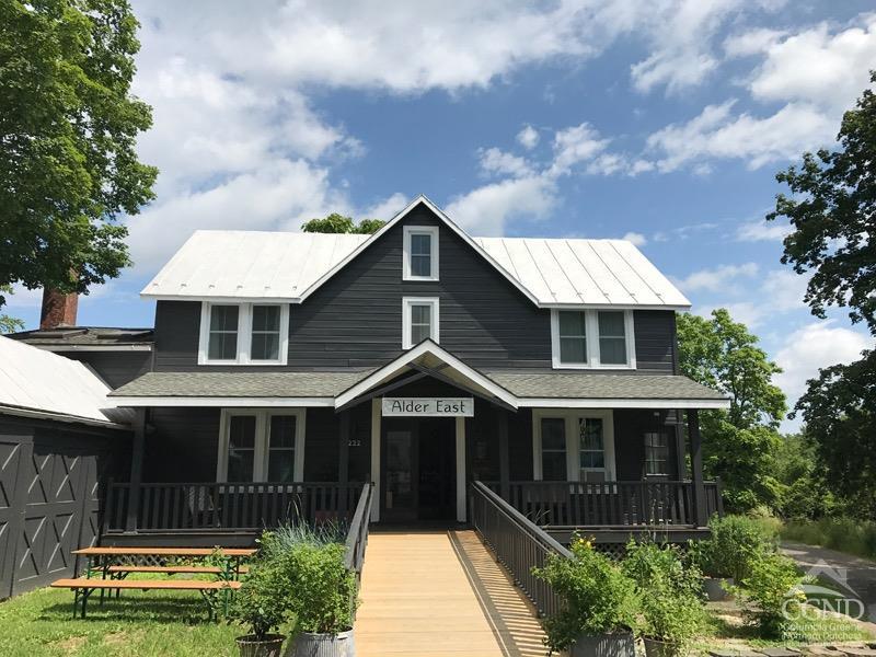 a front view of a house with a garden