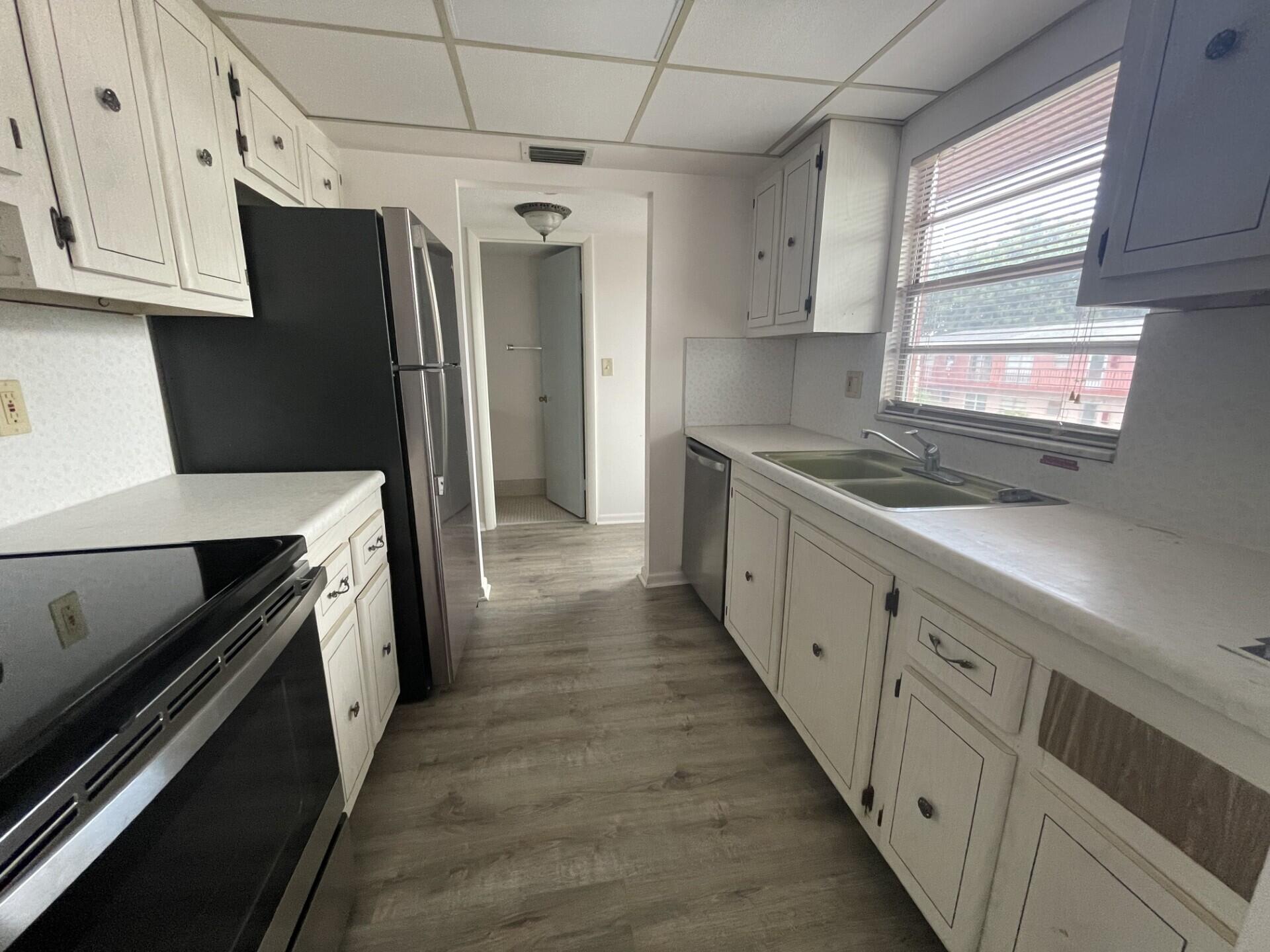 a kitchen with stainless steel appliances a refrigerator and a stove