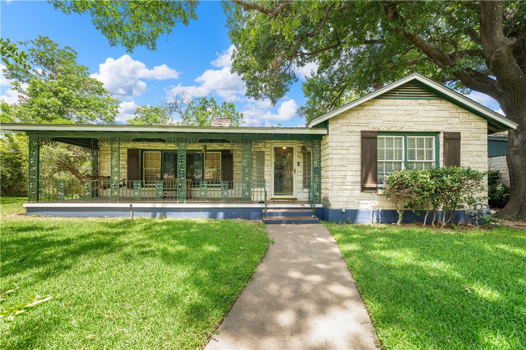 a front view of house with yard and green space