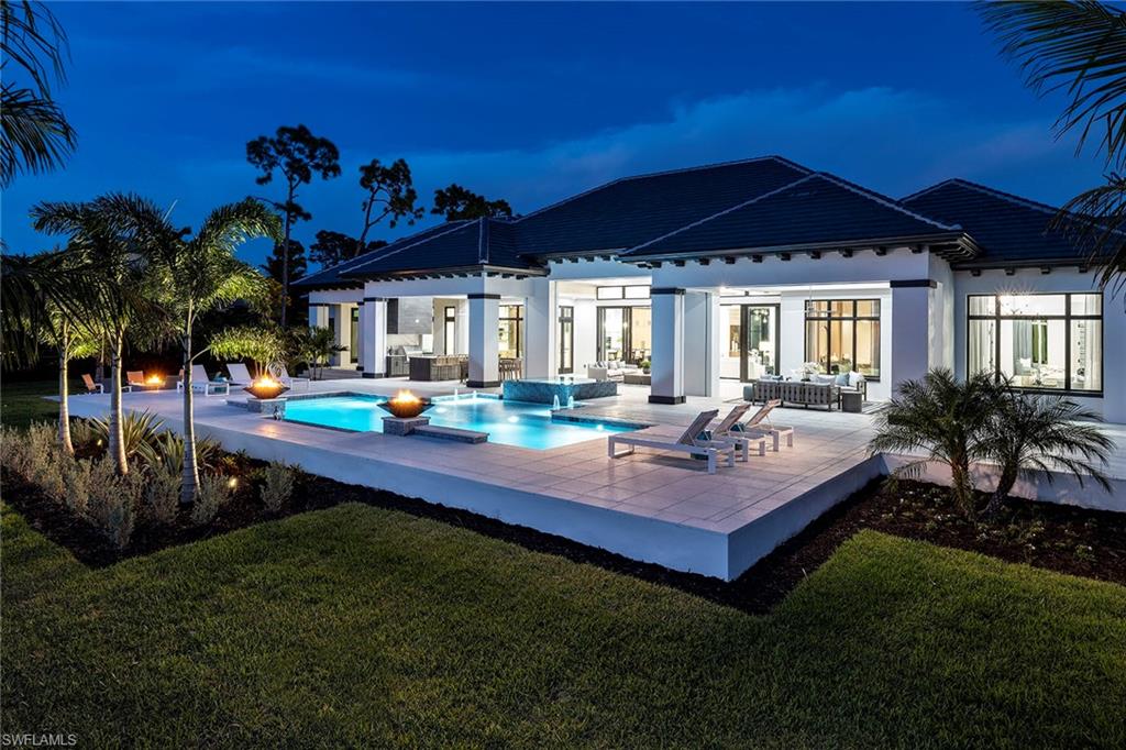 a view of a house with backyard and patio