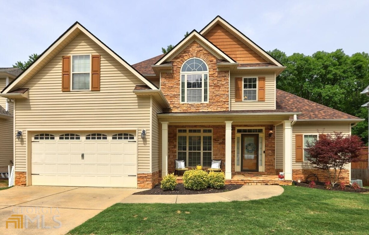 a front view of a house with a yard and garage