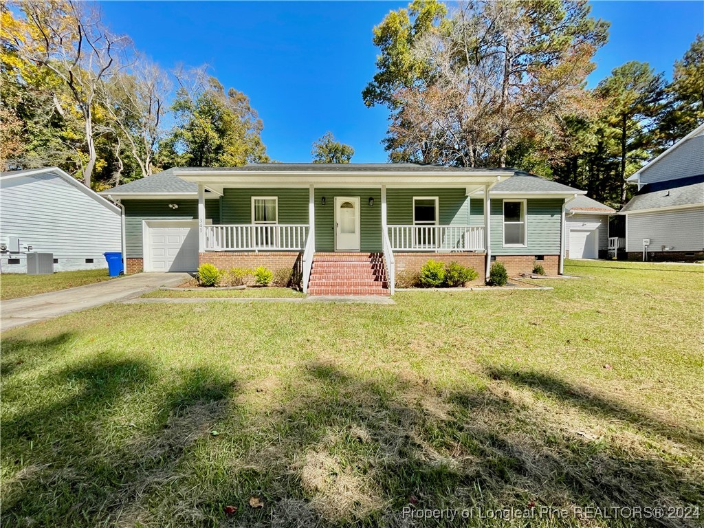 a front view of a house with a yard porch and outdoor seating