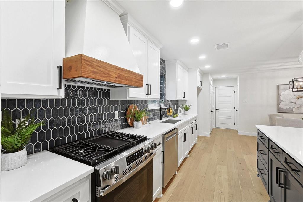 a kitchen with sink stove and cabinets