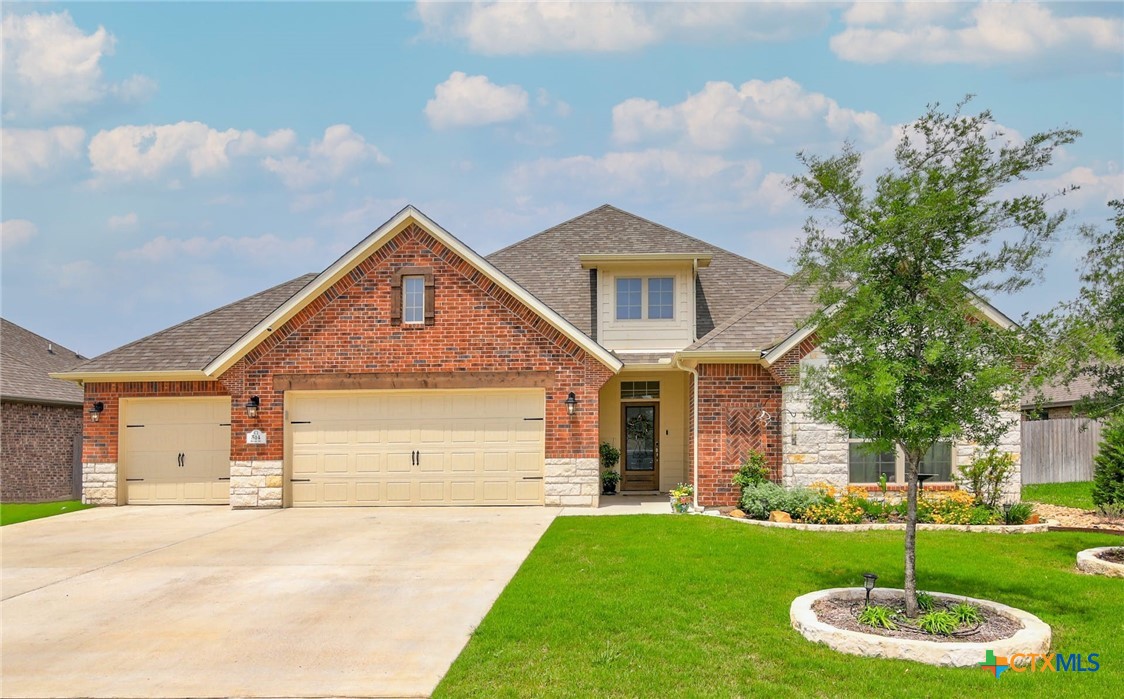 a front view of a house with a yard and garage