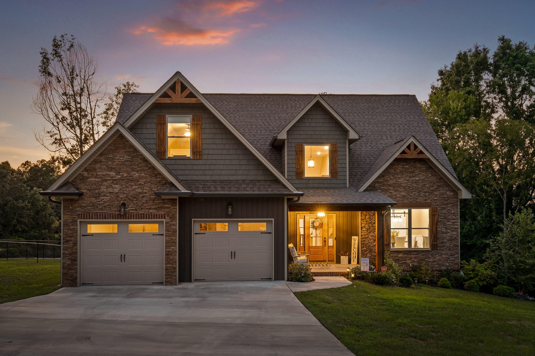 a front view of a house with a yard and a garage