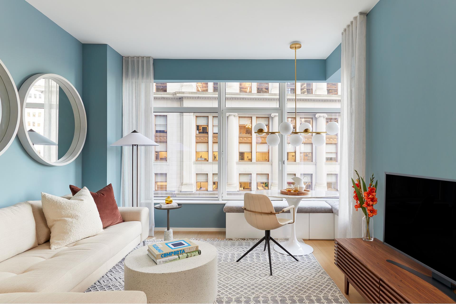 a living room with furniture a rug and a large window