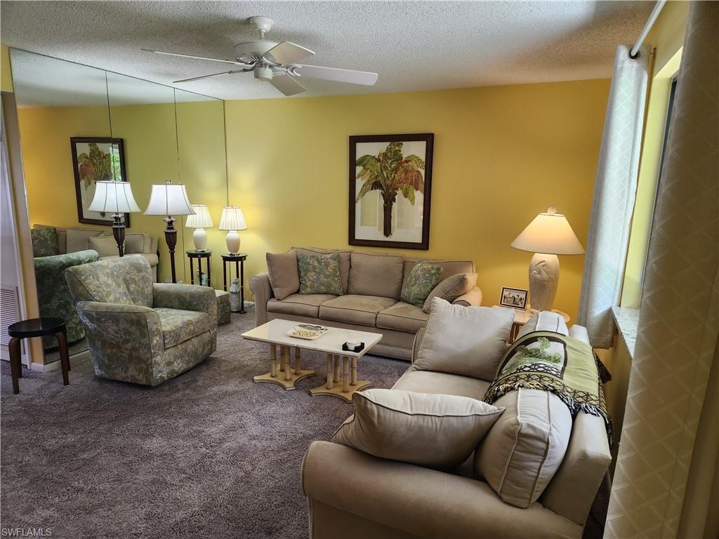 a living room with furniture and a lamp