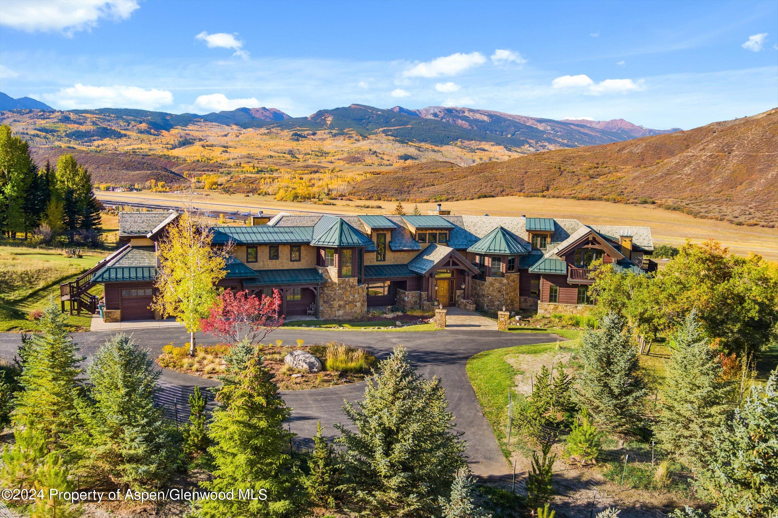 a view of a town with swimming pool and mountains