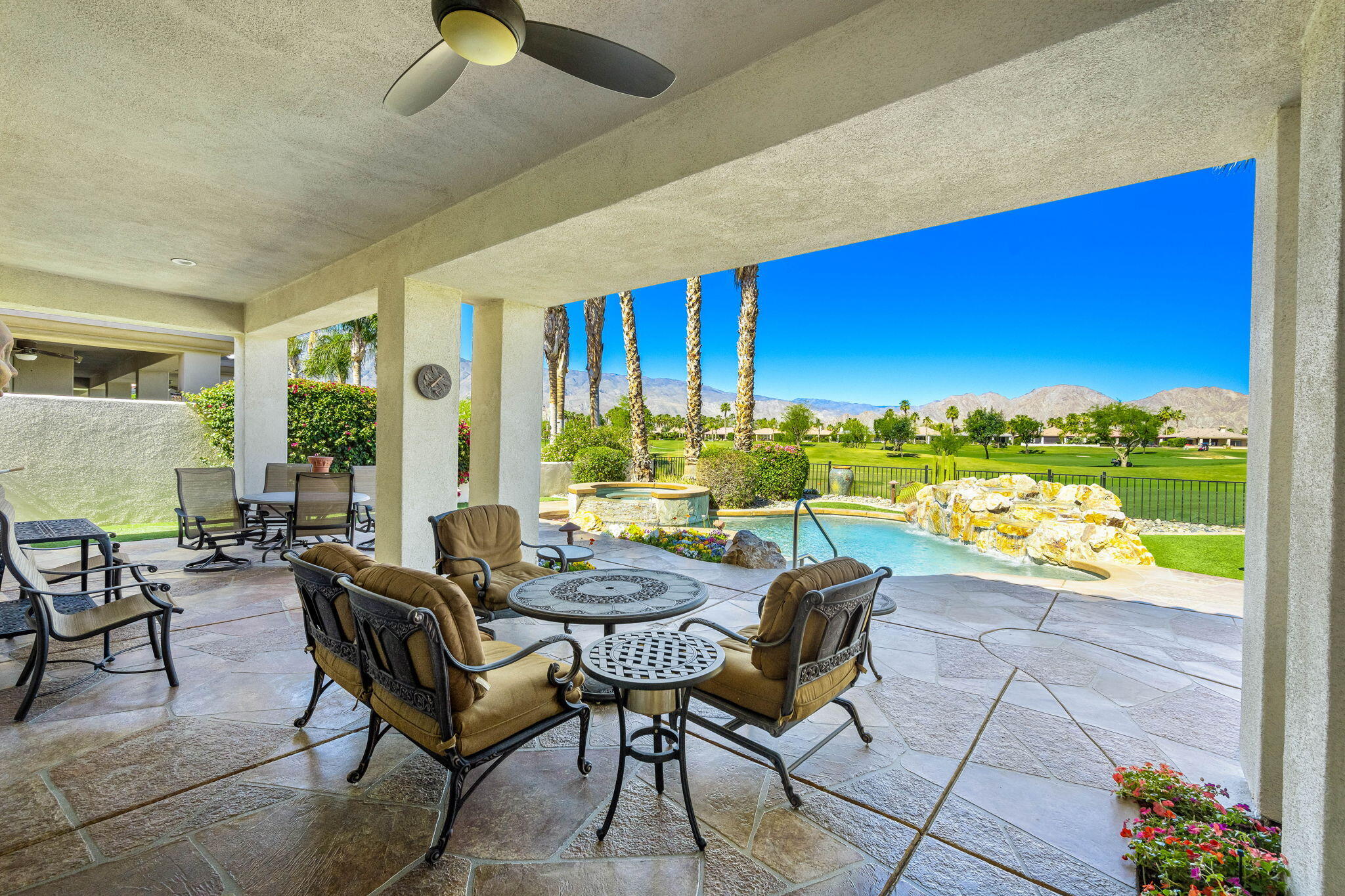 a view of a patio with a dining table and chairs