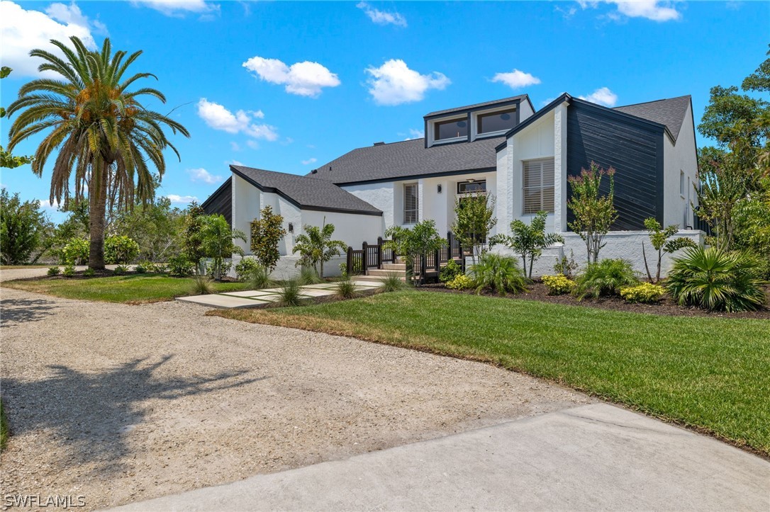 a front view of house with yard and green space