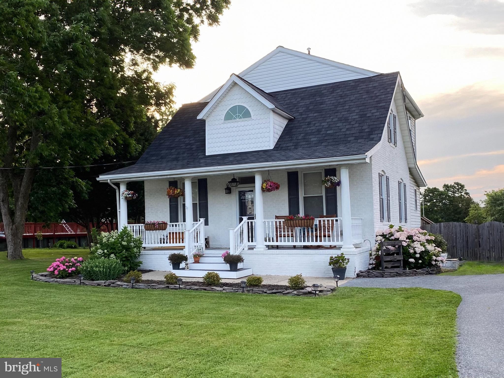 a front view of a house with a garden and patio