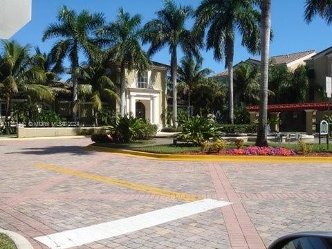 a view of multiple houses with palm trees