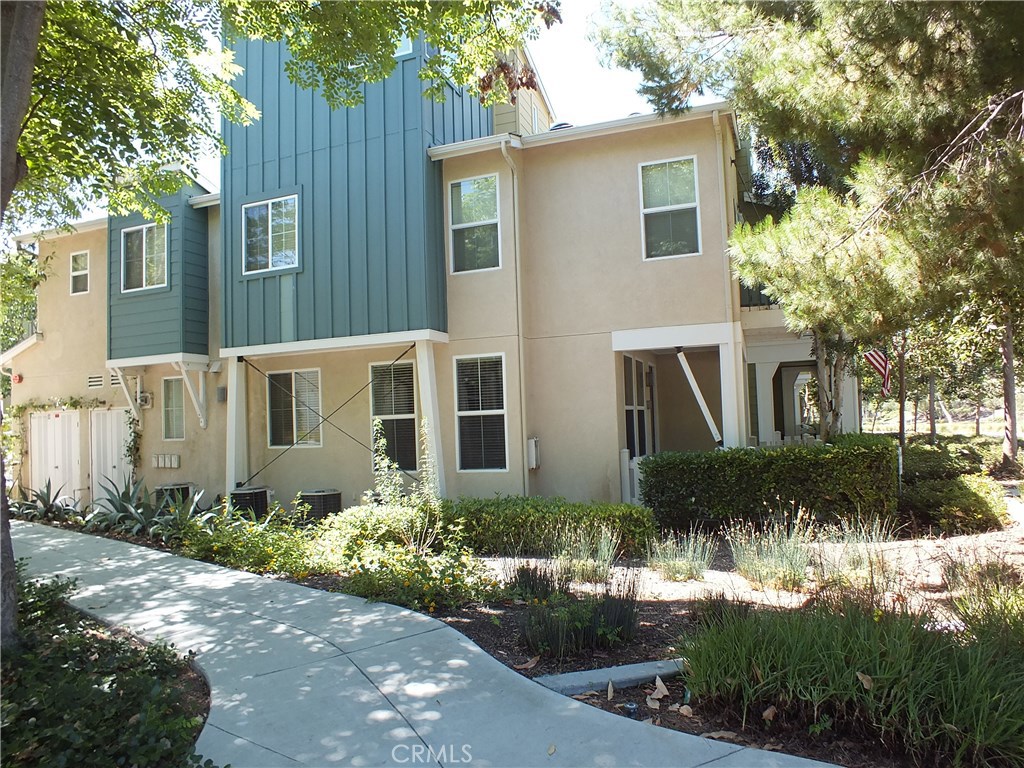 a front view of a house with a yard and outdoor seating