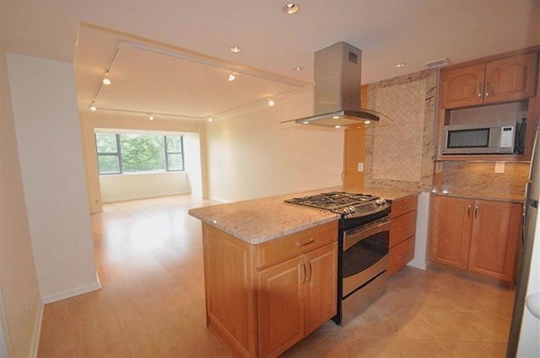 a kitchen with stainless steel appliances granite countertop a stove and a refrigerator