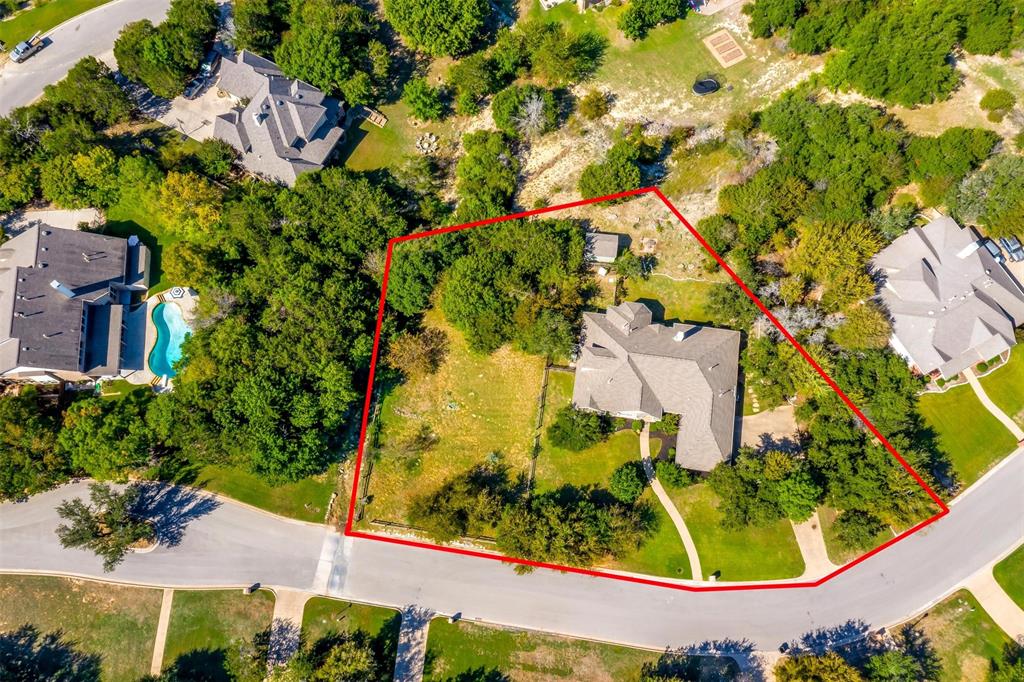 an aerial view of residential house with an outdoor space and seating