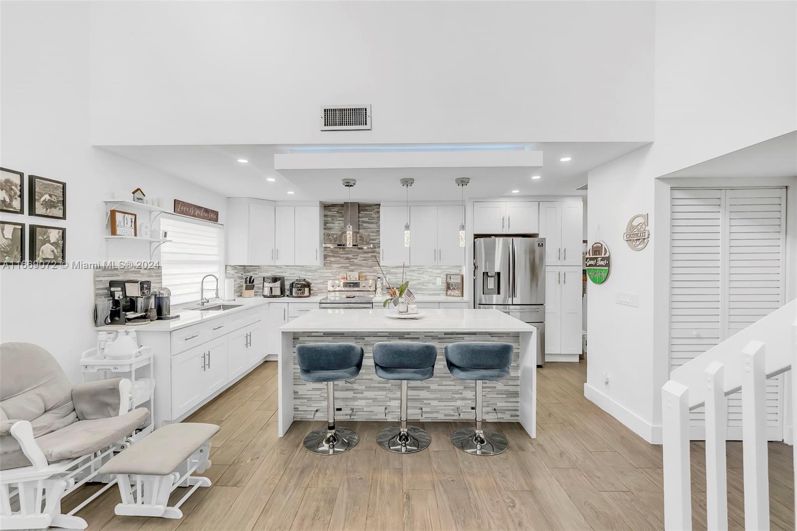 a kitchen with stainless steel appliances granite countertop a sink and cabinets