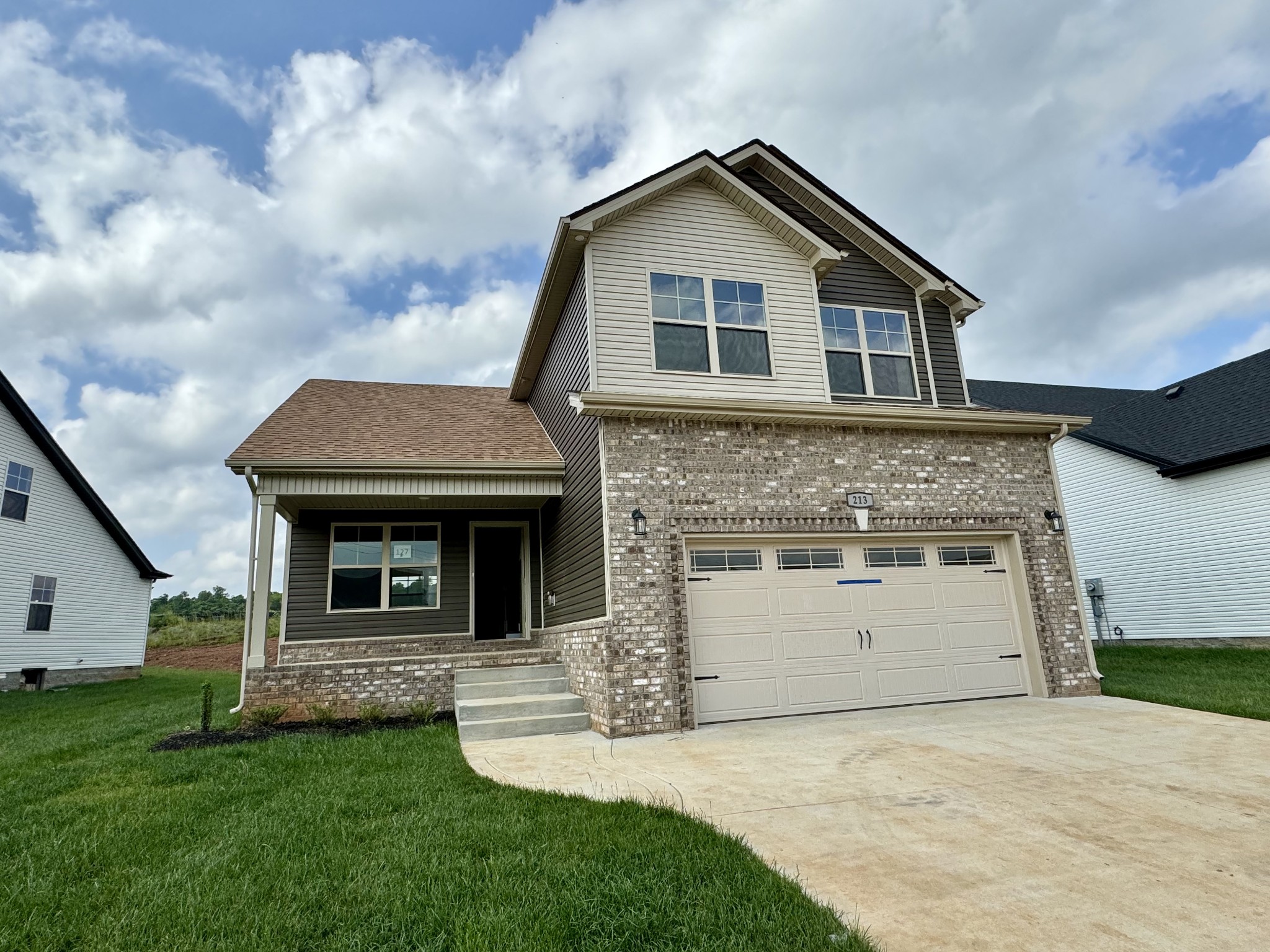 a front view of a house with a yard and garage