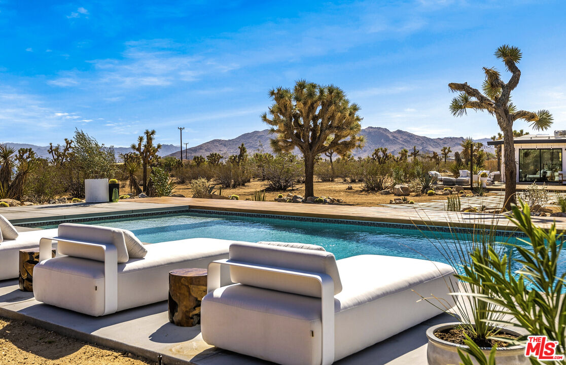 a view of swimming pool with outdoor seating and city view