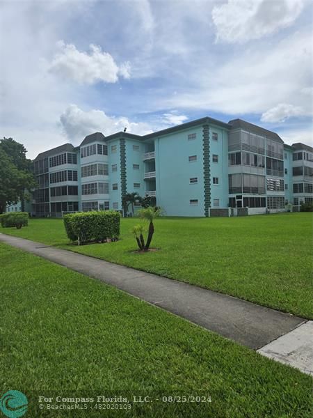 a front view of a building with garden