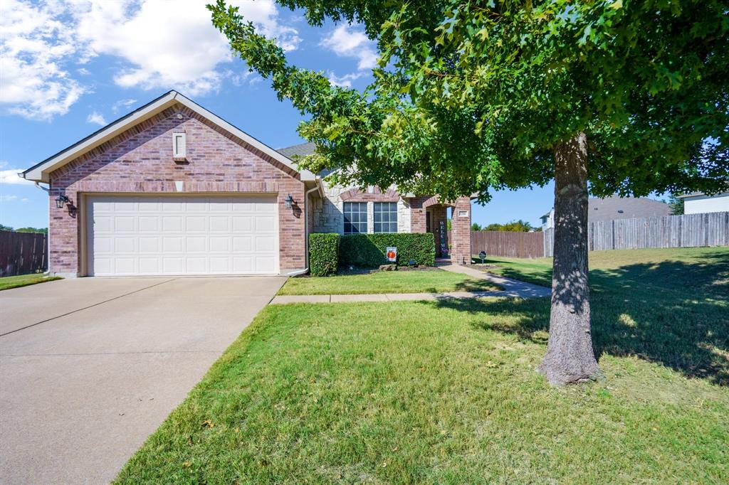 a view of a house with yard and tree s