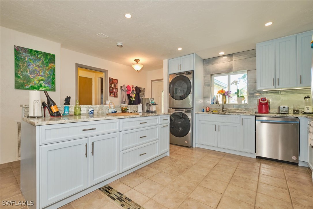 a kitchen with a sink cabinets and stainless steel appliances