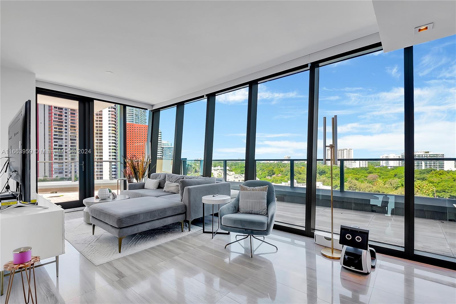 a living room with furniture and floor to ceiling window