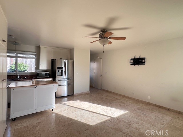 a view of a kitchen with a sink and stainless steel appliances