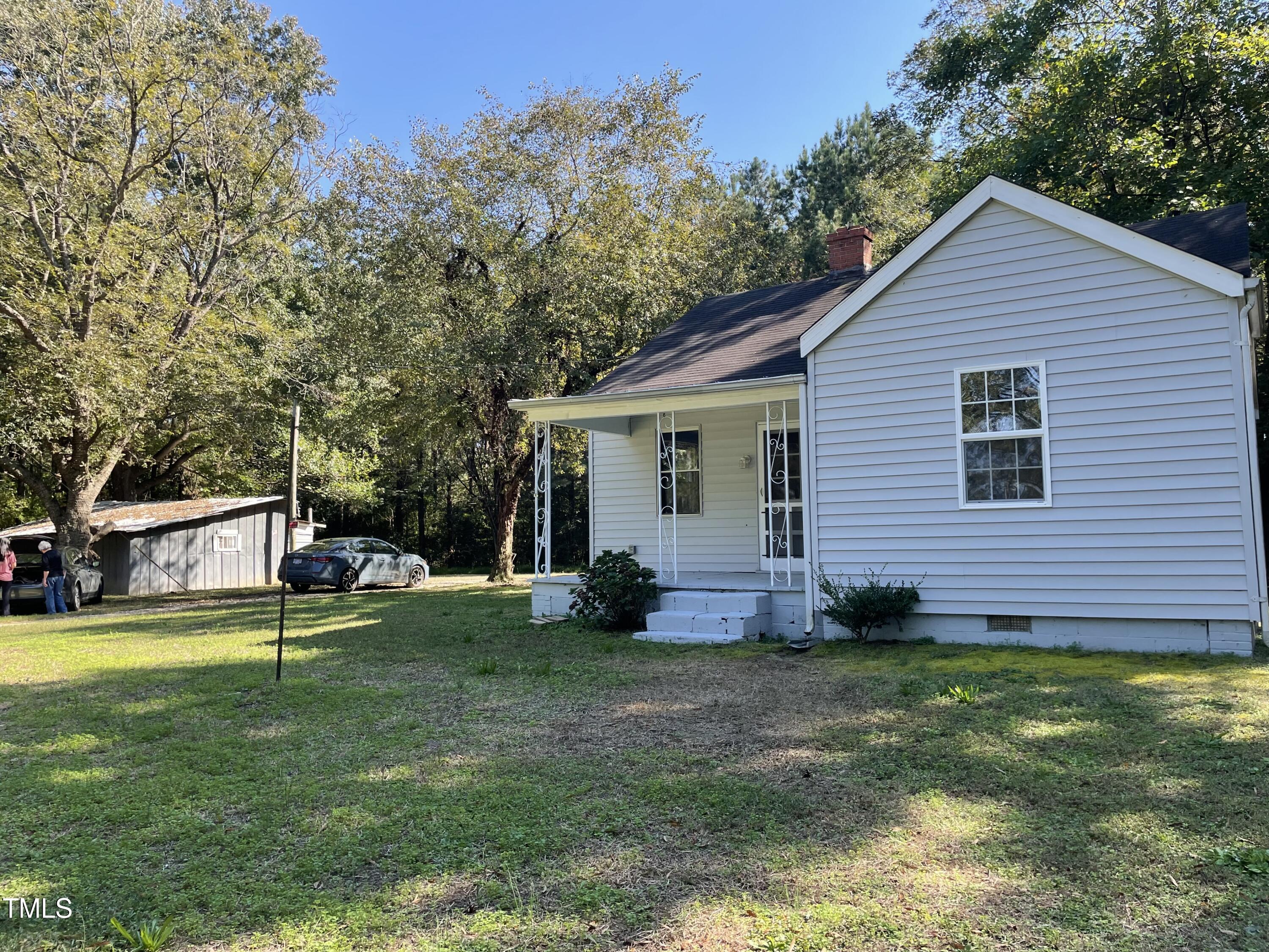 a view of a house with a yard and sitting area