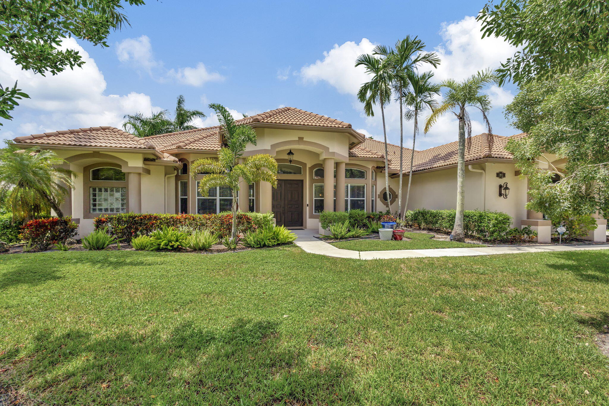 a front view of a house with garden