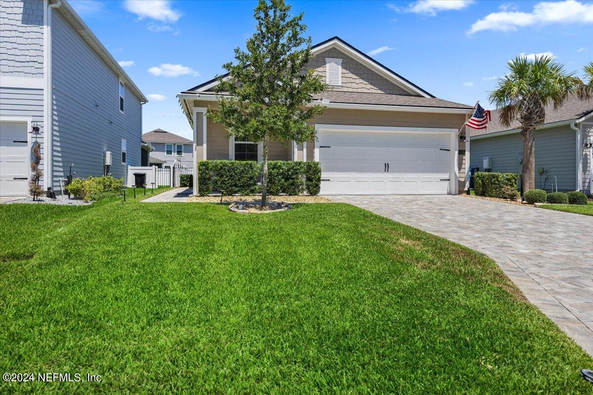 a front view of a house with a yard and garage