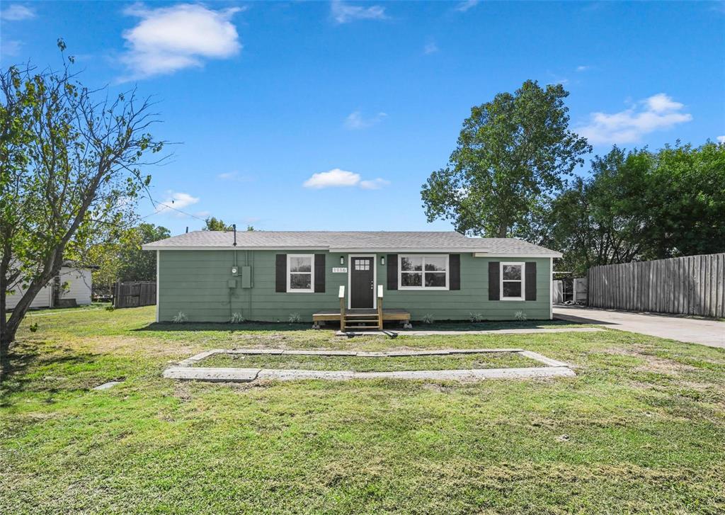 a front view of house with yard and trees