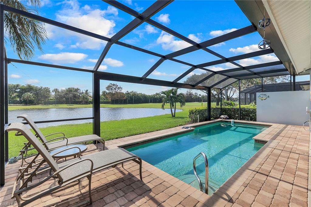 a view of swimming pool with lounge chairs in patio