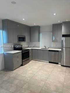 a kitchen with stainless steel appliances a refrigerator sink and cabinets