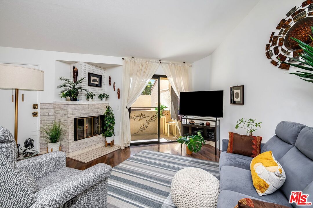 a living room with fireplace furniture and a flat screen tv