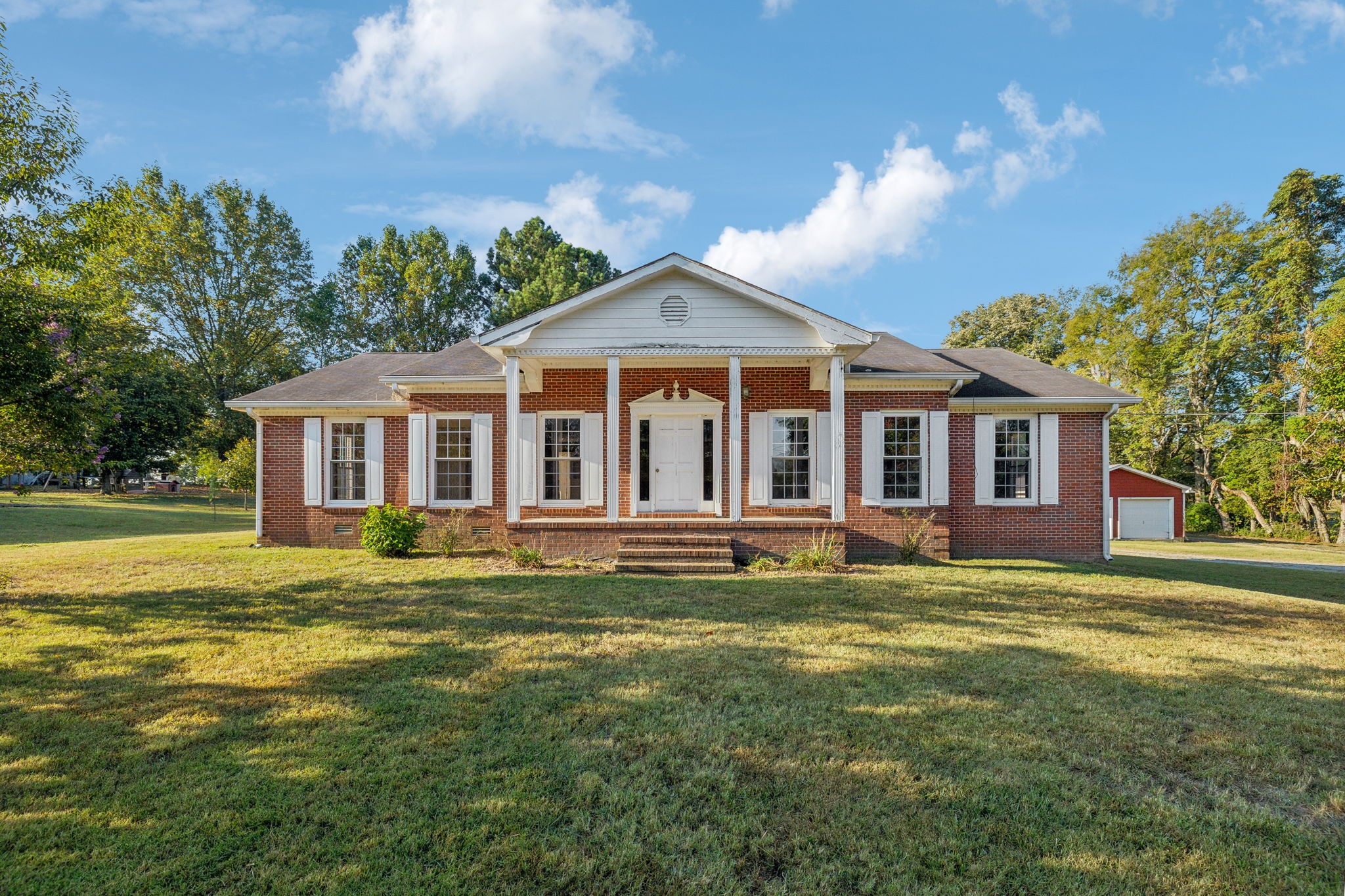 a front view of a house with a garden