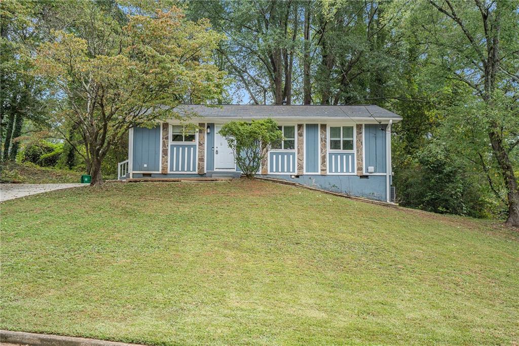 a front view of a house with a garden