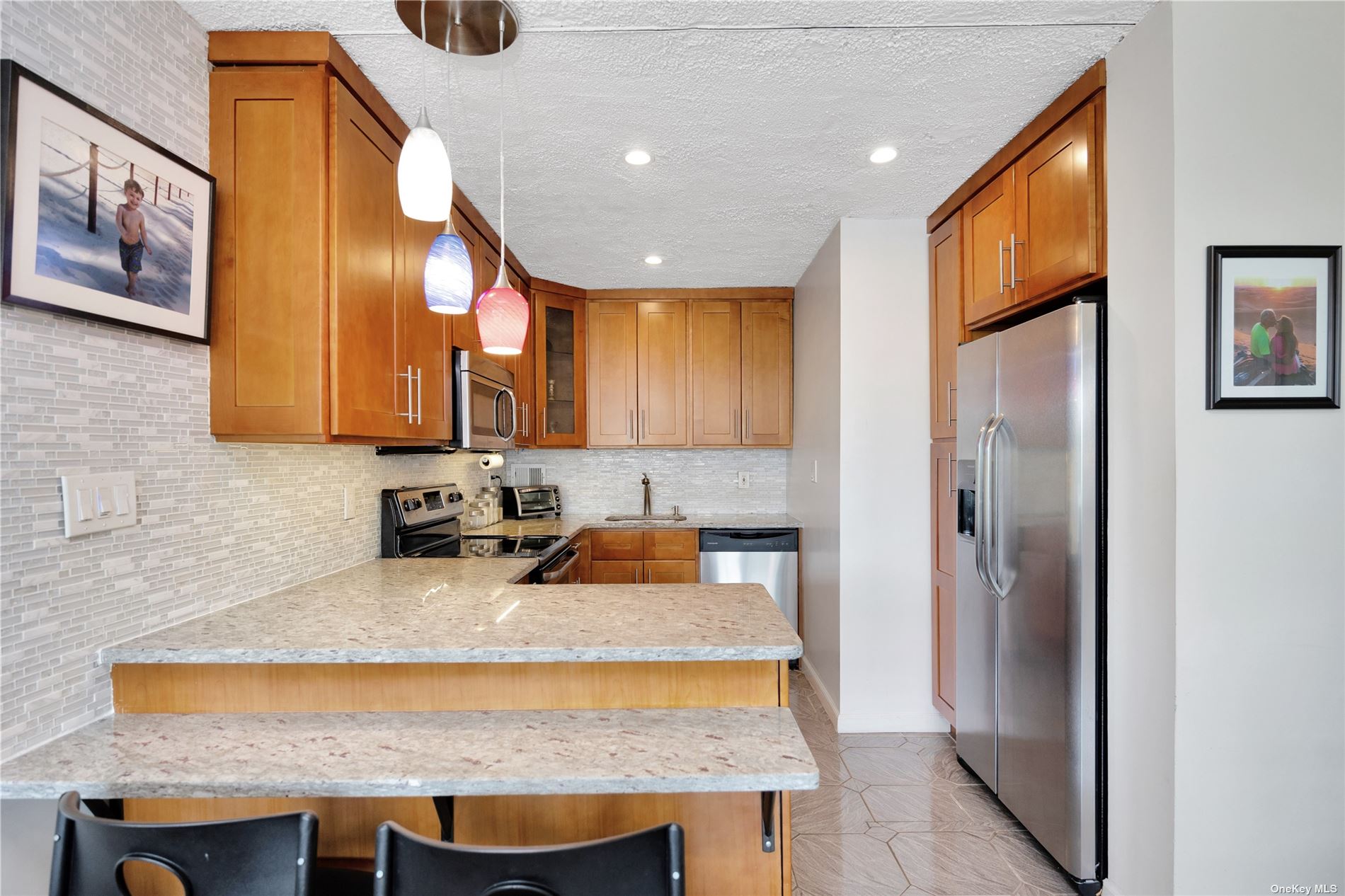 a kitchen with a sink a refrigerator and cabinets