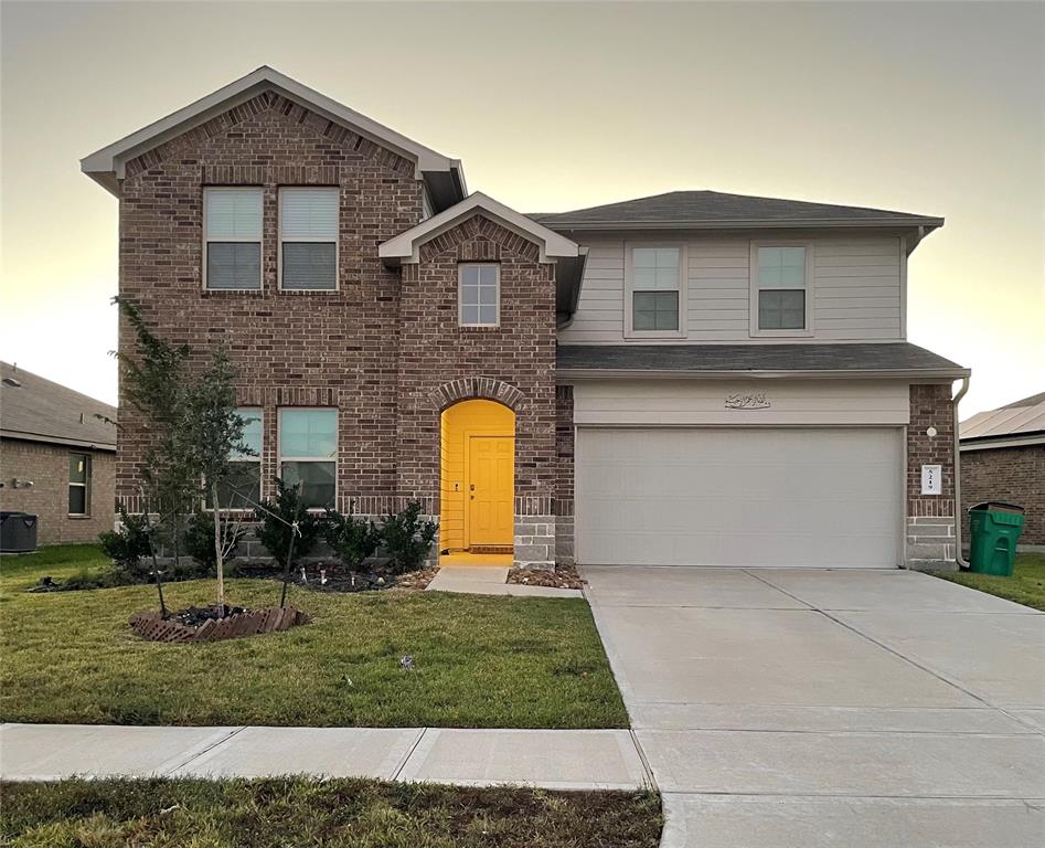 a front view of a house with a yard and garage