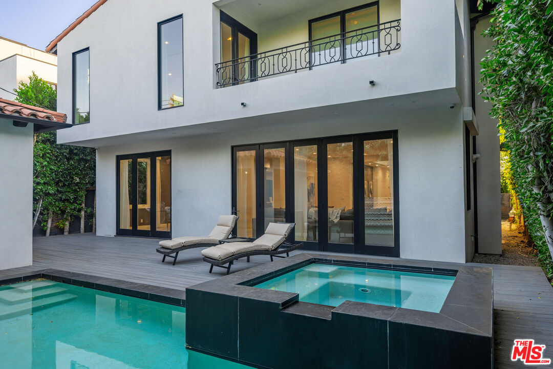 a room with pool table and windows