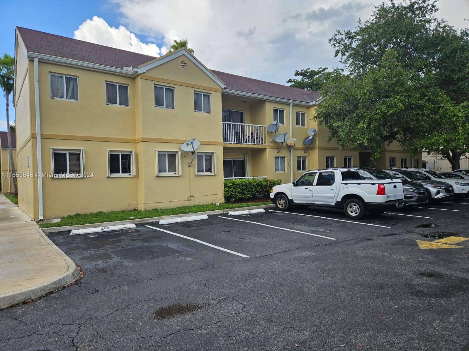 a view of a car park in front of a house