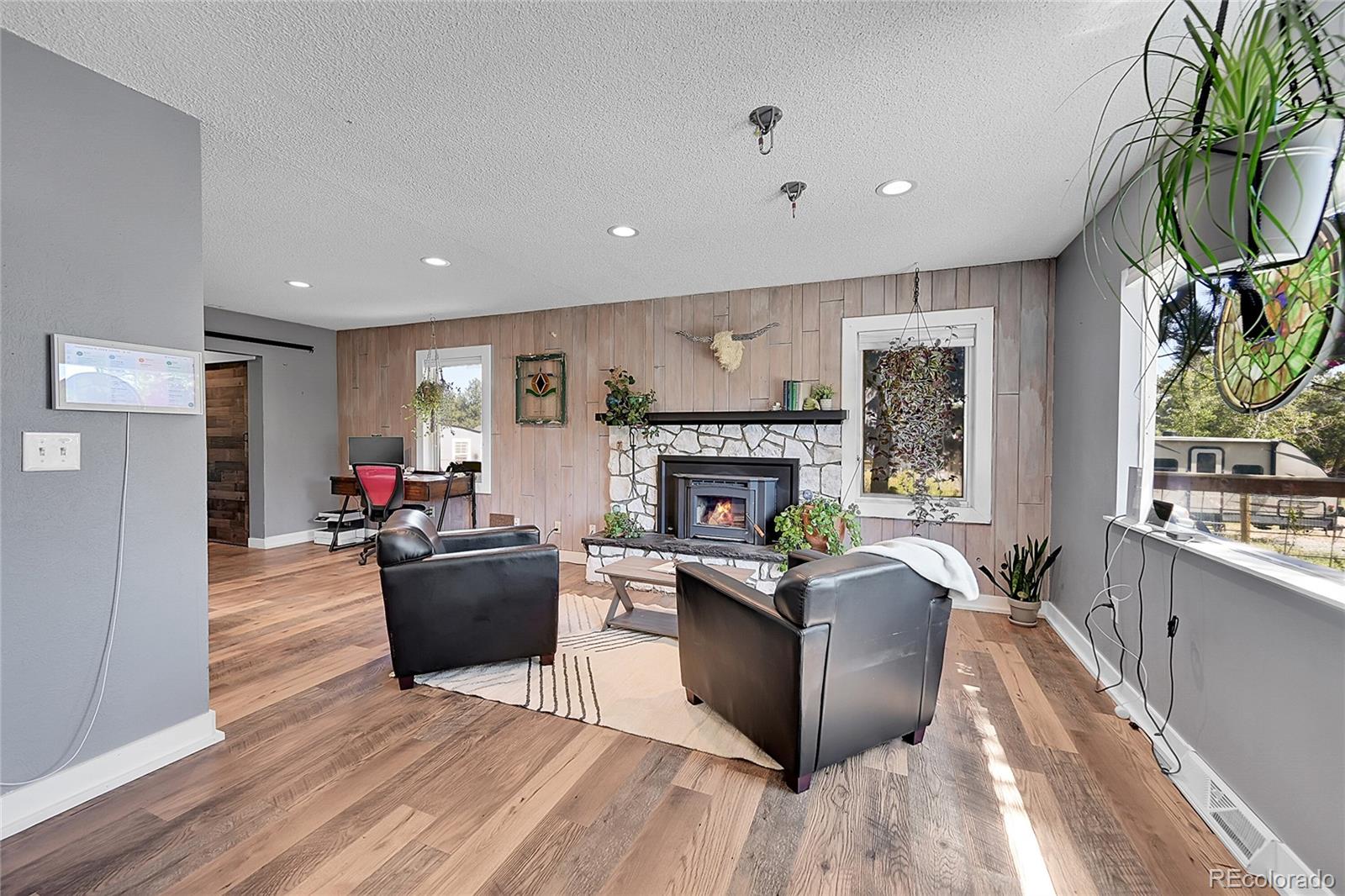 a living room with furniture a flat screen tv and a fireplace