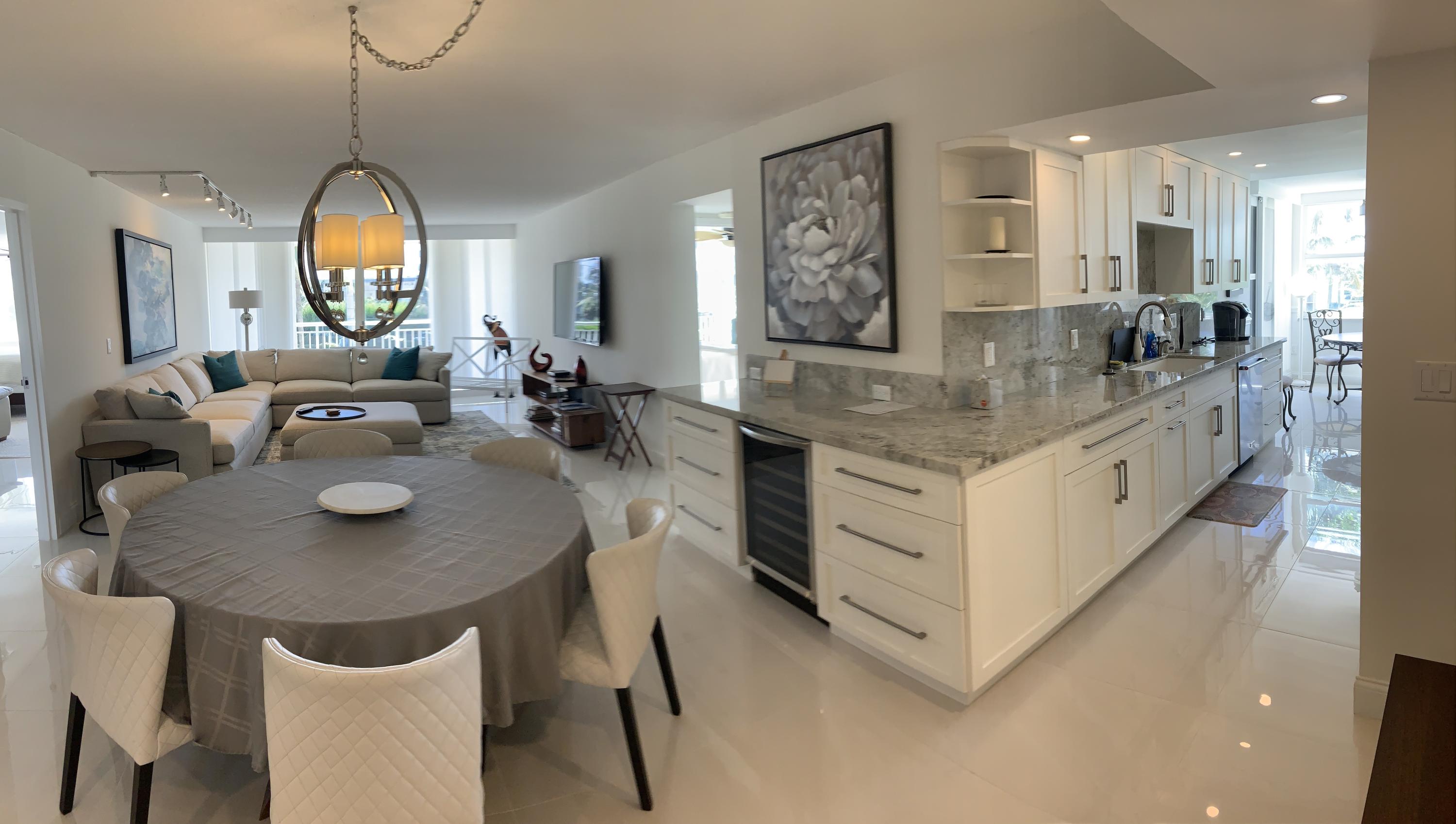 a view of living room with granite countertop furniture a fireplace and a chandelier