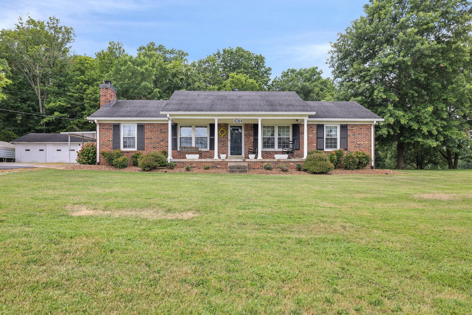 a front view of house with yard and green space